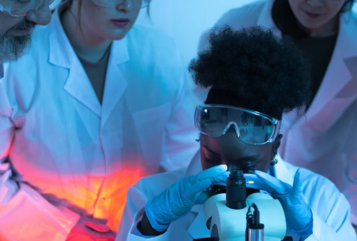 scientists-observing-young-female-colleague-using-2025-09-08-08-37-27-utc copia